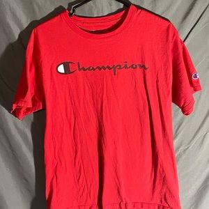 two red champion shirts, one short sleeves and the other long sleeves.